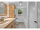 Hall bathroom featuring neutral tile, a tub/shower combo and ample storage at 2585 Regency E Dr, Tucker, GA 30084
