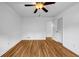Well-lit bedroom with ceiling fan, featuring hardwood floors and a closet at 2585 Regency E Dr, Tucker, GA 30084