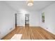 Spacious bedroom features hardwood floors, a modern light fixture, and an ensuite bathroom at 2585 Regency E Dr, Tucker, GA 30084