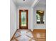 Welcoming foyer with decorative front door, wood floors, and a sidelight window for natural light at 2585 Regency E Dr, Tucker, GA 30084