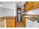 Kitchen featuring stainless steel refrigerator, granite countertops, wood cabinetry and laminate floors at 2585 Regency E Dr, Tucker, GA 30084