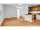 Spacious living room with light-colored laminate floors and a view of the kitchen area at 2585 Regency E Dr, Tucker, GA 30084