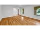 Bright living room with hardwood floors, white walls and view to adjacent room and window at 2585 Regency E Dr, Tucker, GA 30084