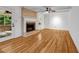 Spacious living room featuring hardwood floors, a brick fireplace, and access to an outdoor patio at 2585 Regency E Dr, Tucker, GA 30084
