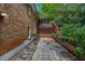Backyard patio with brick siding and a partially covered wooden deck perfect for outdoor living at 2585 Regency E Dr, Tucker, GA 30084