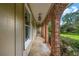 Covered porch featuring brick archways, outdoor lighting, and a view of the lawn at 2585 Regency E Dr, Tucker, GA 30084
