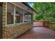 A screened porch with ceiling fan leads to a spacious deck, ideal for outdoor entertaining and relaxation at 2585 Regency E Dr, Tucker, GA 30084