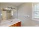 Well-lit bathroom features a single sink vanity with a large mirror and a shower at 310 Willow Ln, Temple, GA 30179
