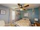 A charming bedroom is decorated with a blue accent wall and a white metal bed frame at 310 Willow Ln, Temple, GA 30179