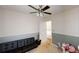 A bedroom with a ceiling fan, carpet, and some furniture at 310 Willow Ln, Temple, GA 30179