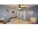 A quaint bedroom with a ceiling fan, neutral colors, and lots of natural light at 310 Willow Ln, Temple, GA 30179