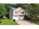 Charming two-story home with a two-car garage and nicely landscaped front yard at 310 Willow Ln, Temple, GA 30179