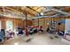 Spacious unfinished garage with exposed studs, a messy floor, and lots of storage at 310 Willow Ln, Temple, GA 30179