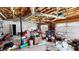 Messy and cluttered garage interior with exposed ceiling and two car garage doors at 310 Willow Ln, Temple, GA 30179