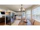 Bright kitchen with an adjacent dining table and view of stainless steel refrigerator at 310 Willow Ln, Temple, GA 30179