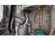 Small mechanical room with HVAC system, water heater, and wrapped pipes and insulation at 310 Willow Ln, Temple, GA 30179
