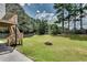 Expansive backyard featuring a stone fire pit, perfect for outdoor gatherings and relaxation at 1226 Kelly Nelson Ct, Lawrenceville, GA 30043