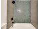Beautiful gray and blue tiling in modern bathroom shower and bath at 1226 Kelly Nelson Ct, Lawrenceville, GA 30043