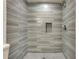 Shower with stylish blue-gray tile and mosaic floors at 1226 Kelly Nelson Ct, Lawrenceville, GA 30043