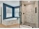 Beautiful bathroom featuring a marble-tiled shower and soaking tub with two windows at 1226 Kelly Nelson Ct, Lawrenceville, GA 30043