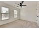 Bright, carpeted bedroom with two windows and a ceiling fan at 1226 Kelly Nelson Ct, Lawrenceville, GA 30043