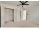 Carpeted bedroom featuring a walk-in closet and a ceiling fan at 1226 Kelly Nelson Ct, Lawrenceville, GA 30043