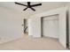 Bright bedroom features neutral carpet, a ceiling fan, and an open closet at 1226 Kelly Nelson Ct, Lawrenceville, GA 30043