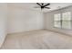 Bedroom with large window providing natural light and neutral color carpet at 1226 Kelly Nelson Ct, Lawrenceville, GA 30043
