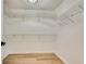 Walk-in closet with shelving for storage and light wood look floors at 1226 Kelly Nelson Ct, Lawrenceville, GA 30043