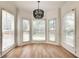 The dining room is surrounded by bright windows and features modern lighting and light wood flooring at 1226 Kelly Nelson Ct, Lawrenceville, GA 30043