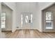 Bright entryway with soaring ceiling, light wood floors and decorative glass front door at 1226 Kelly Nelson Ct, Lawrenceville, GA 30043