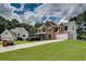 Traditional brick home with manicured lawn and long driveway, providing curb appeal and ample parking at 1226 Kelly Nelson Ct, Lawrenceville, GA 30043