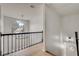 Hallway featuring hardwood floors, black railing, and a decorative light fixture at 1226 Kelly Nelson Ct, Lawrenceville, GA 30043