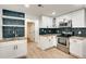 Well-lit kitchen with stainless steel appliances, granite countertops, modern white cabinets, and backsplash at 1226 Kelly Nelson Ct, Lawrenceville, GA 30043