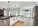 Open kitchen featuring a large island, granite countertops, stainless appliances, and hardwood floors at 1226 Kelly Nelson Ct, Lawrenceville, GA 30043