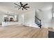 Spacious living room featuring a modern staircase, hardwood floors, and an open layout at 1226 Kelly Nelson Ct, Lawrenceville, GA 30043