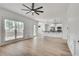 Open concept living room showcasing the modern kitchen, hardwood floors, and natural light at 1226 Kelly Nelson Ct, Lawrenceville, GA 30043