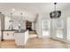 Open layout showcases kitchen, living and dining areas, modern lighting, and a fireplace at 1226 Kelly Nelson Ct, Lawrenceville, GA 30043