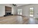 Living room with hardwood floors, lots of natural light, and a modern fireplace at 1226 Kelly Nelson Ct, Lawrenceville, GA 30043