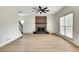 Bright living room featuring a modern fireplace, ceiling fan, and beautiful hardwood floors at 1226 Kelly Nelson Ct, Lawrenceville, GA 30043