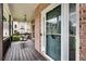 Inviting covered front porch includes wood flooring and a comfortable porch swing at 1226 Kelly Nelson Ct, Lawrenceville, GA 30043