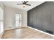 Room with light hardwood floors, and a striking dark accent wall at 1226 Kelly Nelson Ct, Lawrenceville, GA 30043