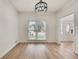 Room with light hardwood floors, large window, and decorative chandelier at 1226 Kelly Nelson Ct, Lawrenceville, GA 30043
