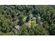 Aerial view of a wooded property in a suburban neighborhood, outlined in white at 1691 Houghton N Ct, Atlanta, GA 30338