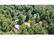 Aerial view of a house nestled among lush green trees in a suburban neighborhood at 1691 Houghton N Ct, Atlanta, GA 30338