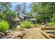 Beautiful backyard view featuring a pond with rock waterfall and lush landscaping at 1691 Houghton N Ct, Atlanta, GA 30338