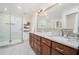 Bright bathroom with double sinks, granite counters, and a glass-enclosed shower at 1691 Houghton N Ct, Atlanta, GA 30338