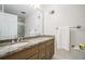 Bathroom with double sinks, granite countertop, and a large mirror at 1691 Houghton N Ct, Atlanta, GA 30338