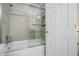Bathroom with tiled shower-tub, glass doors, and modern fixtures at 1691 Houghton N Ct, Atlanta, GA 30338