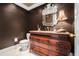 Traditional powder room with marble floors, brown walls and antique vanity at 1691 Houghton N Ct, Atlanta, GA 30338
